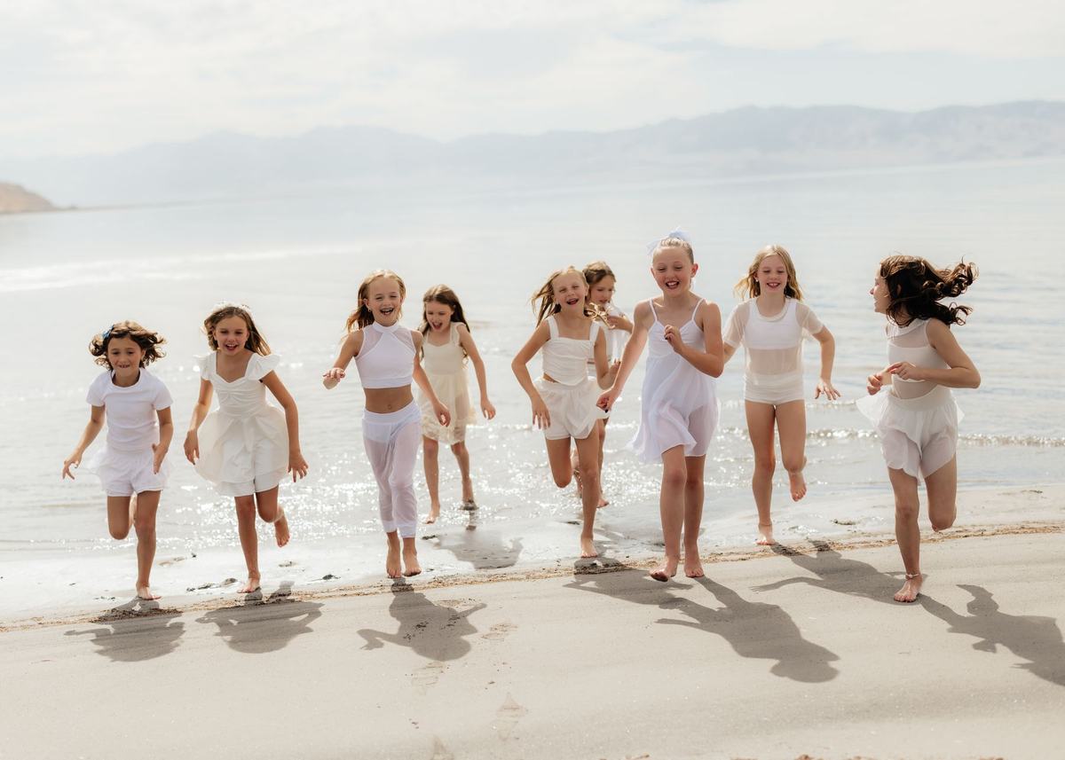 Young Anchor dancers running together along the beach