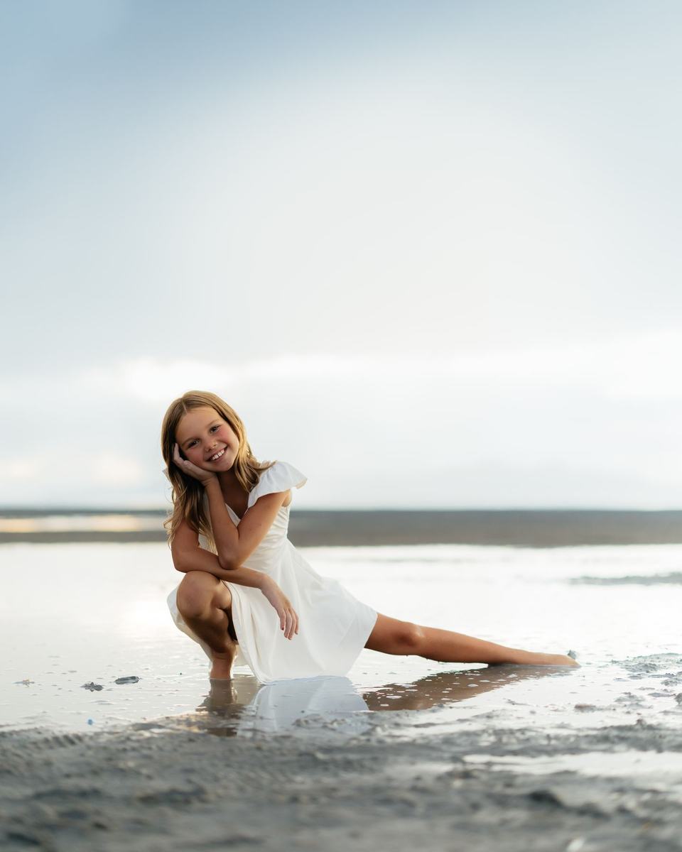 An Anchor dancer smiling on the shoreline