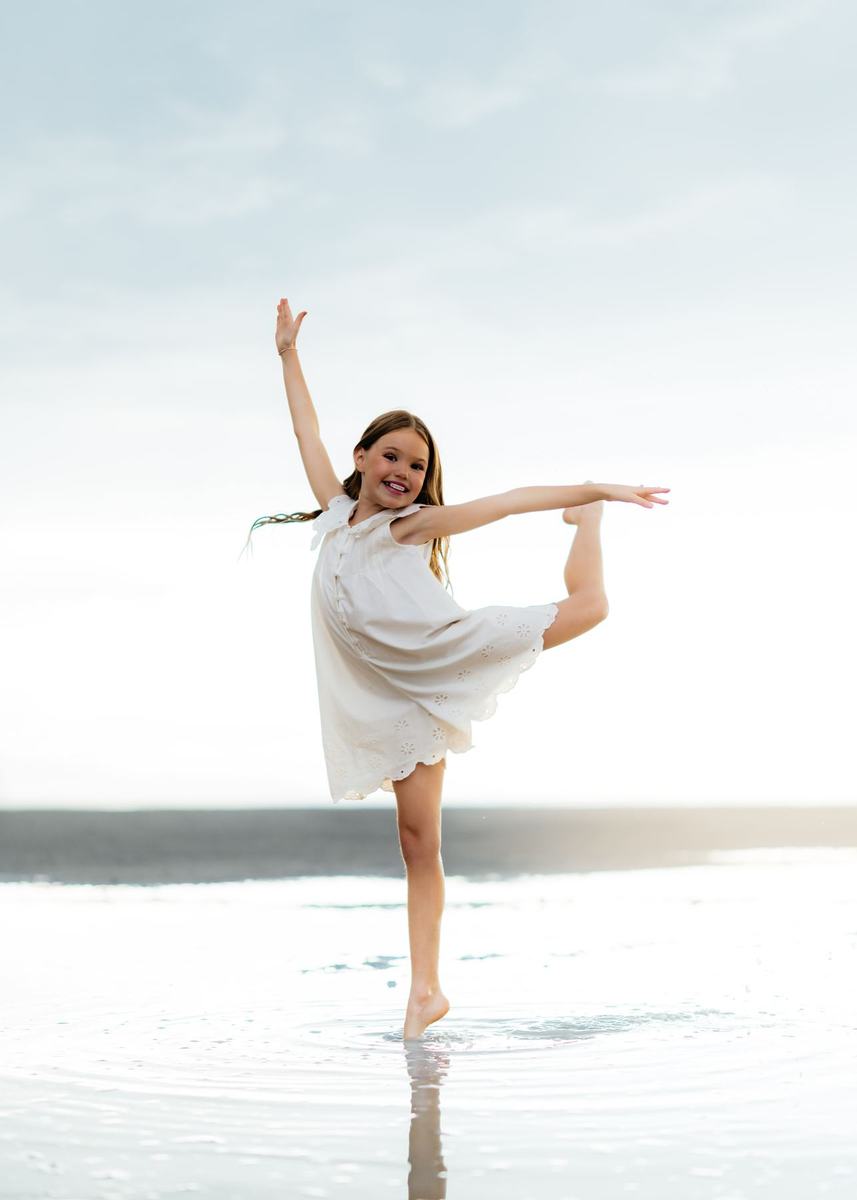 A smiling dancer holding a balance