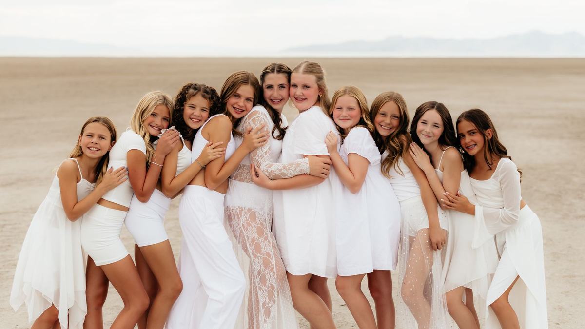 Anchor dancers gathered together, arms around each other