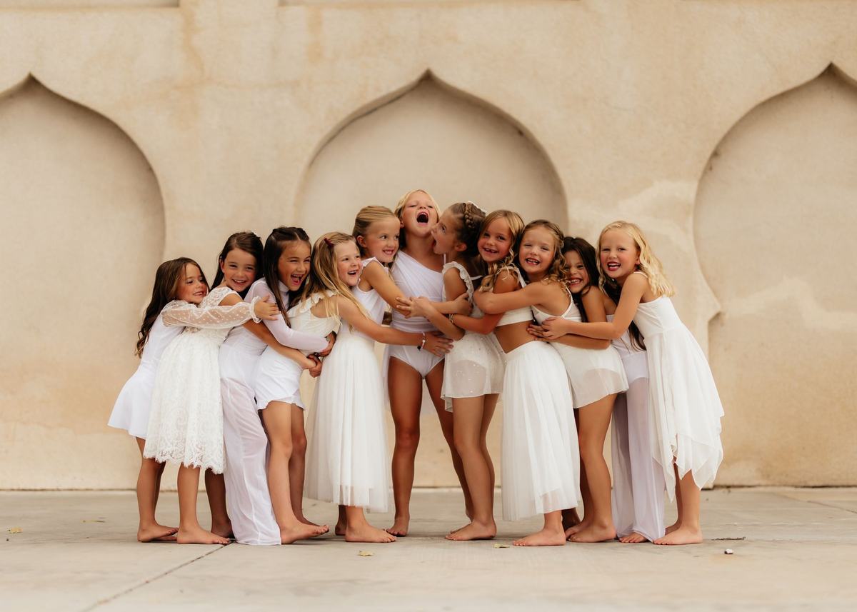 Anchor dancers in a big group hug