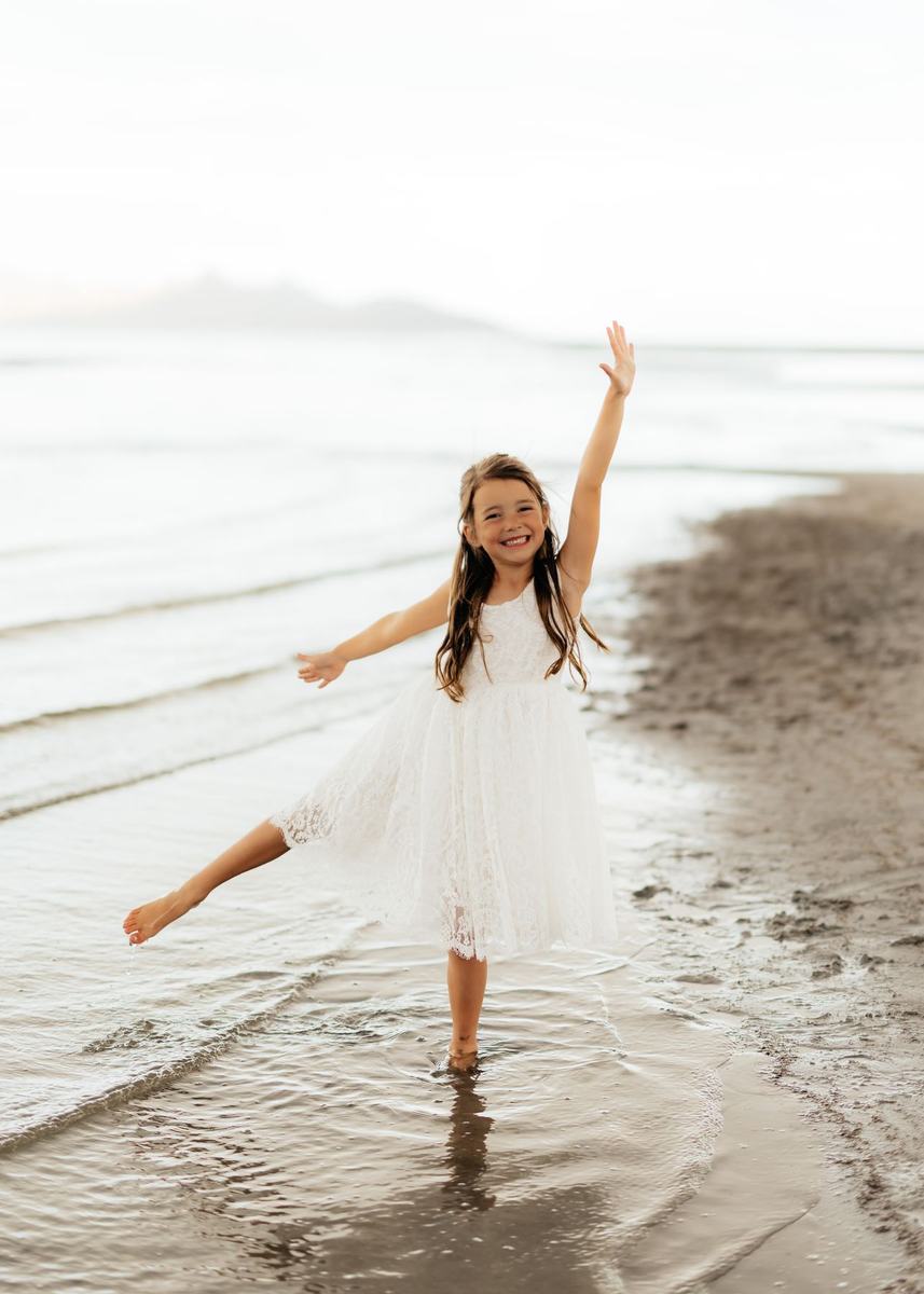 A young dancer playing in the shallow water